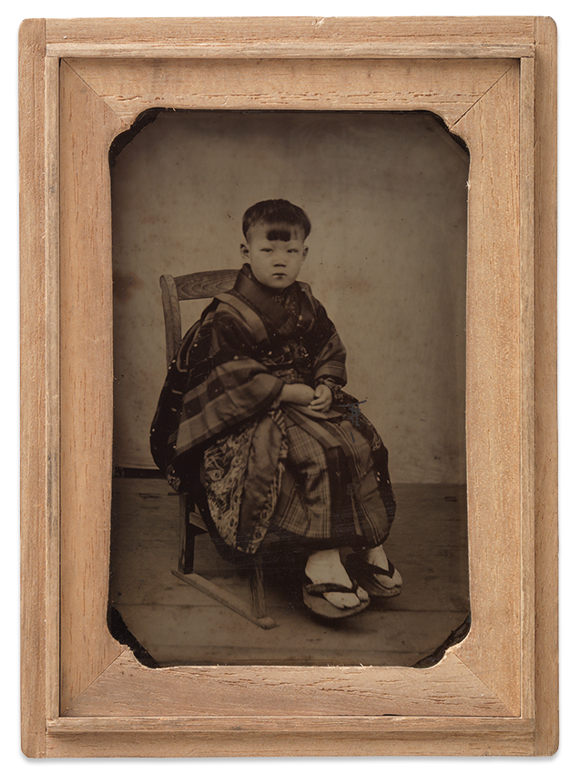 Portrait of young boy in traditional dress c.1875